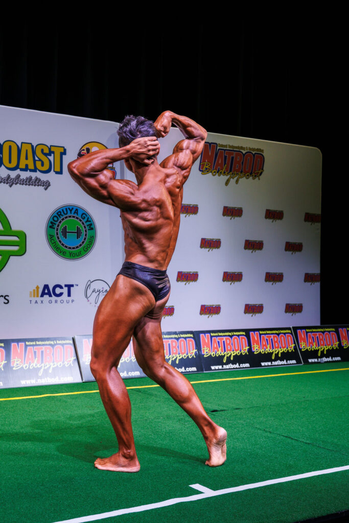 elite natural bodybuilder back pose